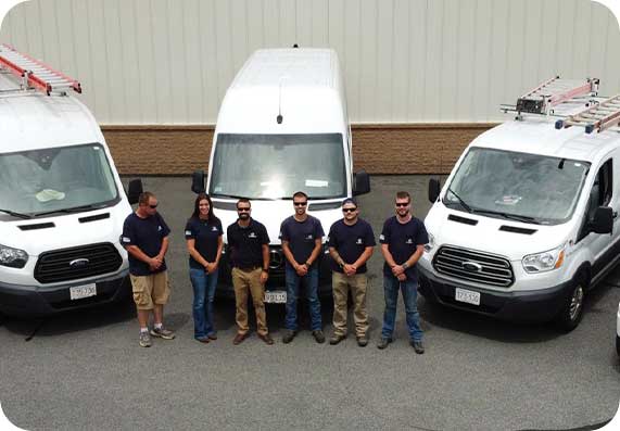 Team of BD Electrical & Solar in front of service vans, showcasing expertise in residential and commercial electrical projects in Southeastern Massachusetts.