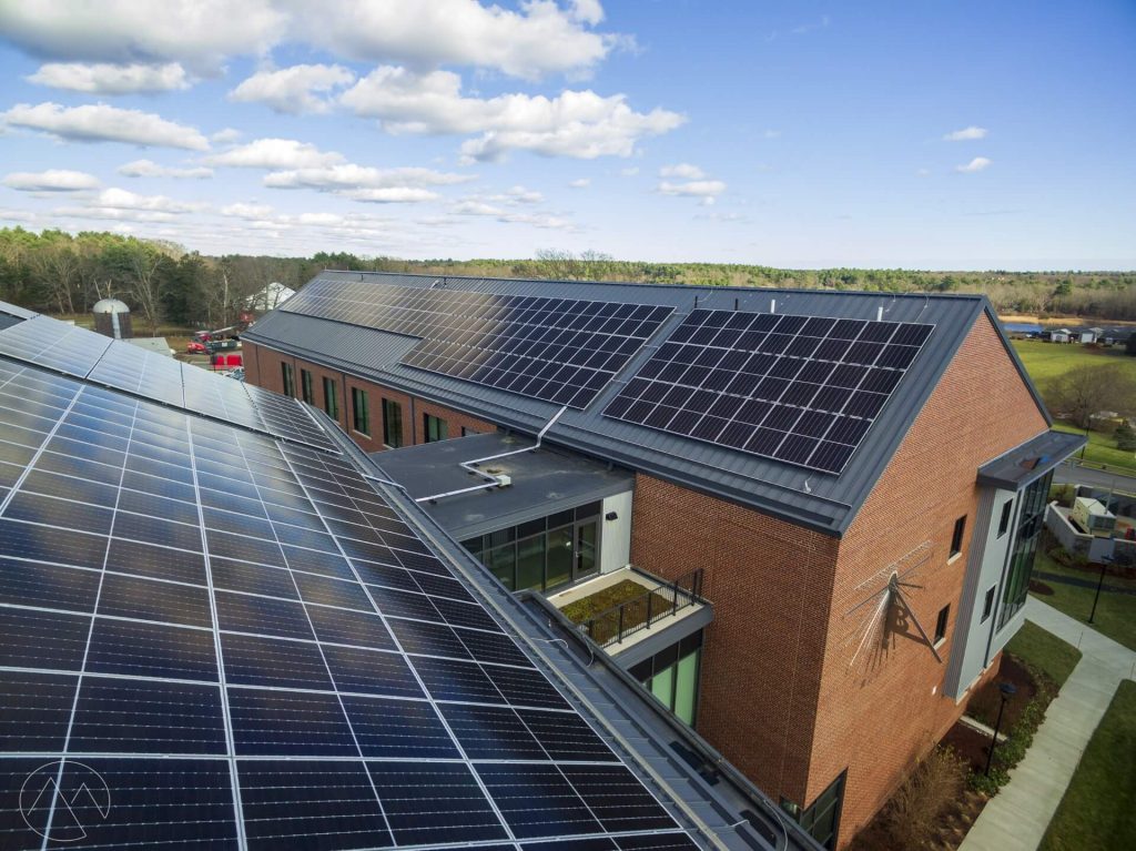 Aerial view of Bristol Aggie County High School showcasing solar panels installed on the roof, emphasizing clean energy solutions and commercial solar power installations by BD Electrical Services.