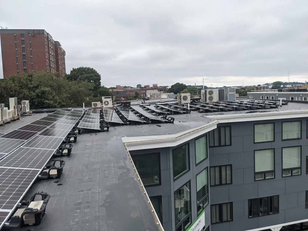 Eleanor Lofts Condos rooftop solar panel installation showcasing multiple solar arrays, enhancing energy efficiency for commercial use in urban setting.