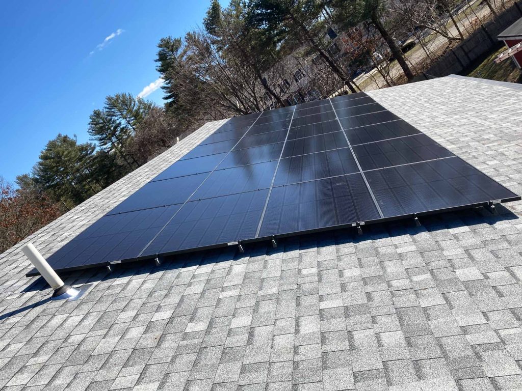 Solar panel installation on a sloped roof of Middleboro Animal Clinic in Middleborough, Massachusetts, showcasing clean energy technology for commercial use.