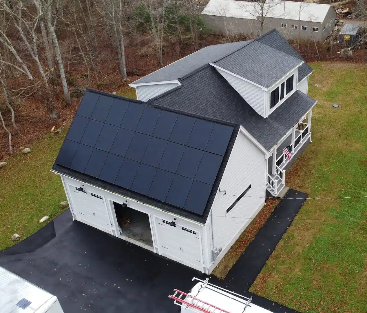 Residential home in Dartmouth, MA with solar panels installed on the roof, showcasing energy-efficient technology and promoting sustainable energy solutions.