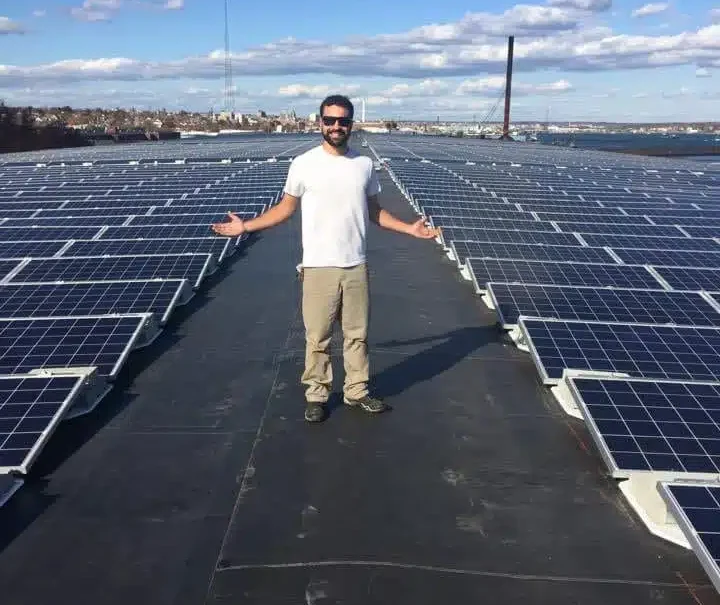 The-Solar-Mile-1 Brett Duguay standing on a solar panel installation, showcasing his expertise in solar energy solutions for BD Electrical & Solar Services.