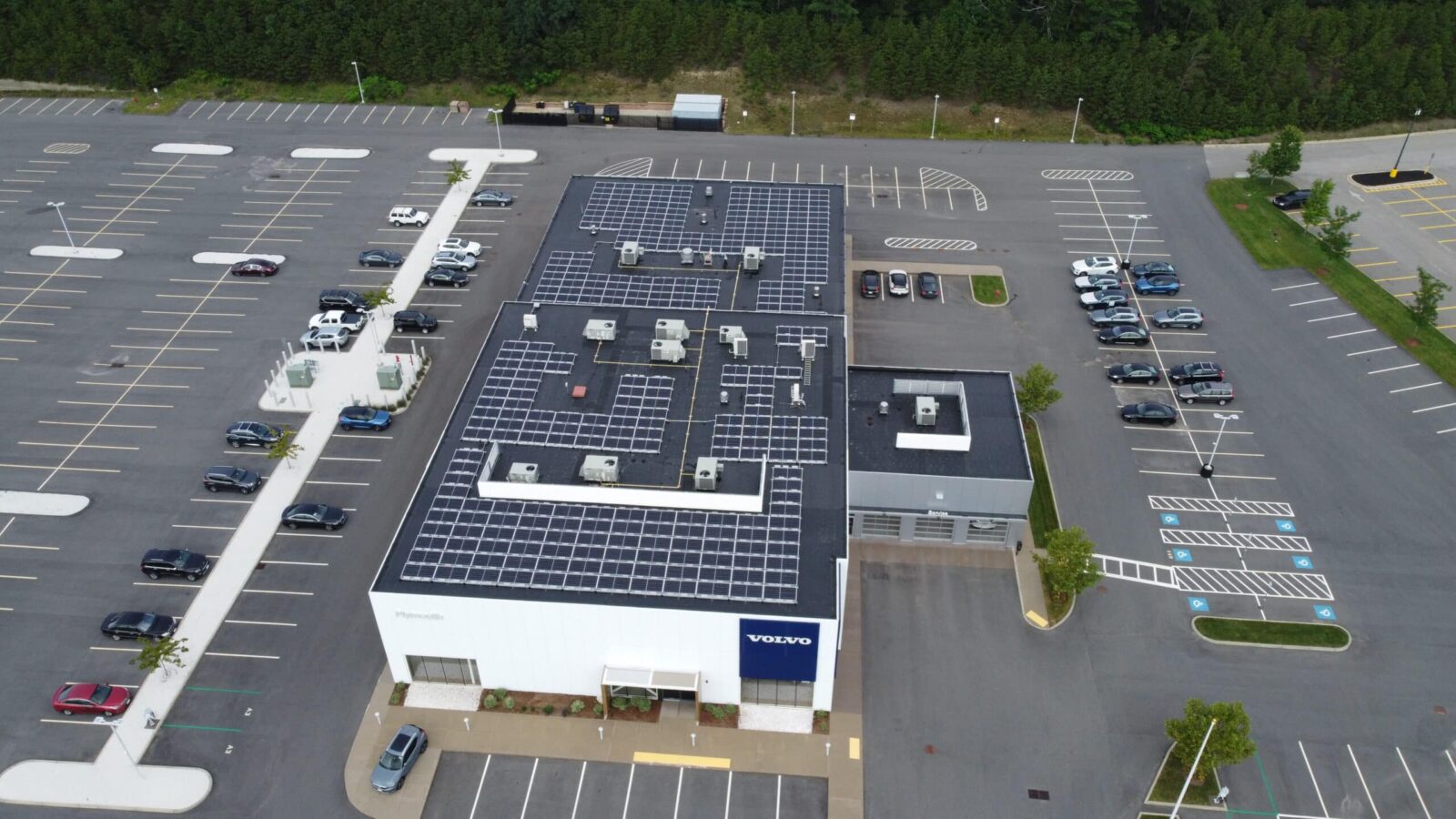 Commercial solar installation on Volvo dealership roof and parking lot